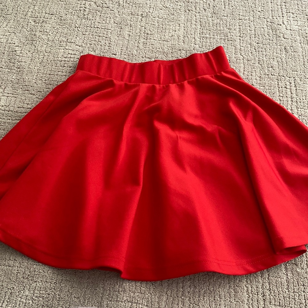red pleaded skirt